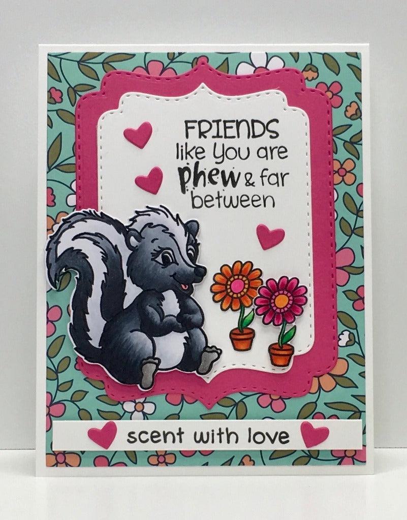 One of two of our stinkin' adorable skunk stamp sets.  Both use the same coordinating die.  We have added a gift, flower, heart and even smelly swirls to give you plenty of options. By Dare 2B Artzy. 