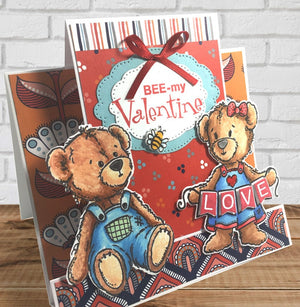 This sweet bear and her banner are ready to brighten up any card or scrapbook page. All the pennant clear stamp sentiments can be stamped directly into the pennant she is holding. By Dare 2B Artzy.