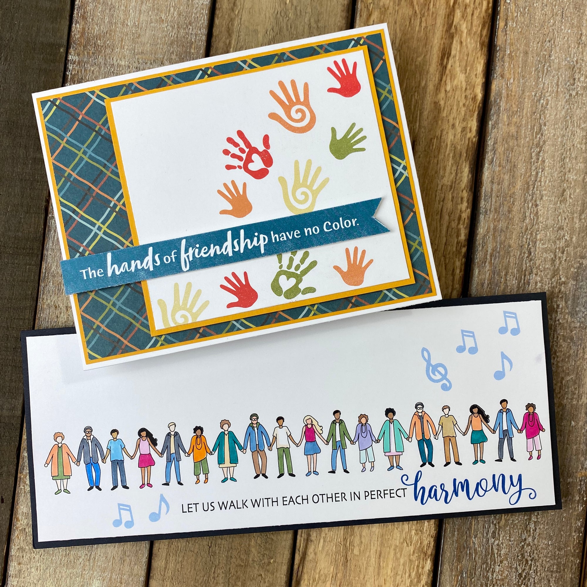 Two handmade cards about standing together in harmony. Images include people standing in a line holding hands and music notes. Uses stamp set, "Harmony" from Dare 2B Artzy.