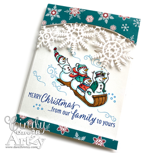 Homemade card sample using the stamp set, "Toboggan Fun" from Dare 2B Artzy.  Card has an image of a snowman family going down a hill on a sled.  